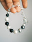 Men’s shell pearl bracelet, Urban Stoic Series Noir Warden, minimal jewelry aesthetic with 316L stainless steel and white copper details.