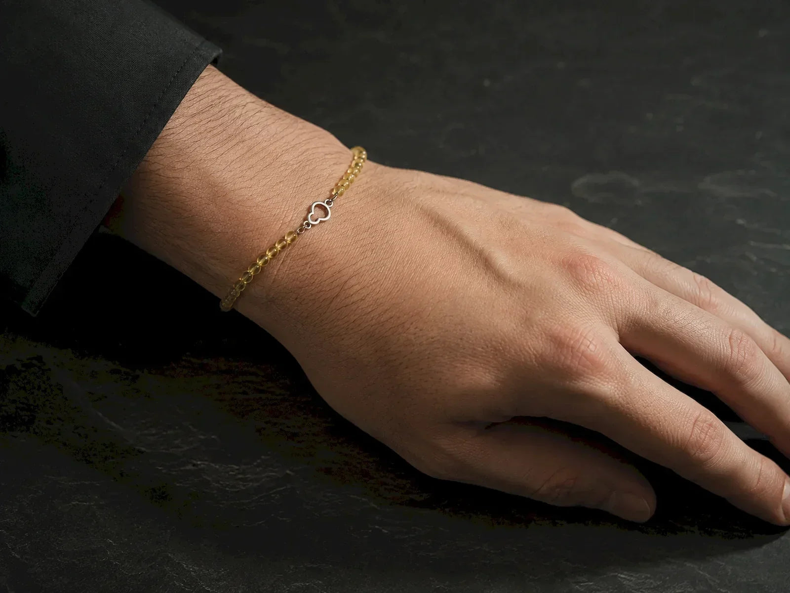Man wearing the Golden Thread golden rutilated quartz and sterling silver gourd bracelet