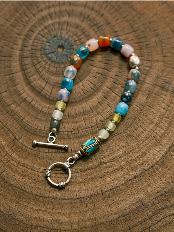 Close-up detail of multicolor agate, natural jade, silver and refined metal elements in Urban Dreamer handmade men’s bracelet