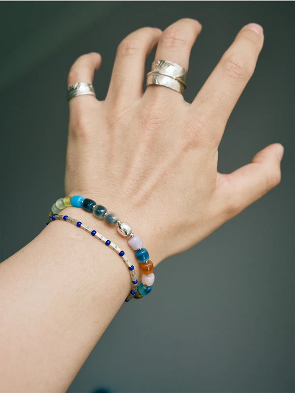Urban Dreamer men’s bracelet stacked with other bracelets, multicolor agate and silver beaded bracelet for layered masculine style