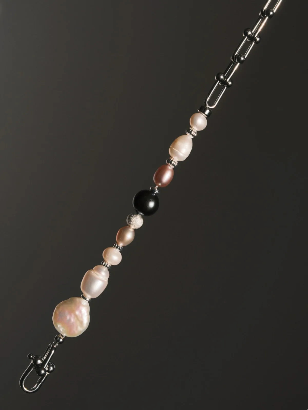 Inspiration mood image for men’s pearl bracelet, urban stoic fashion and quiet luxury masculine style