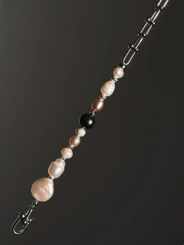 Inspiration mood image for men’s pearl bracelet, urban stoic fashion and quiet luxury masculine style