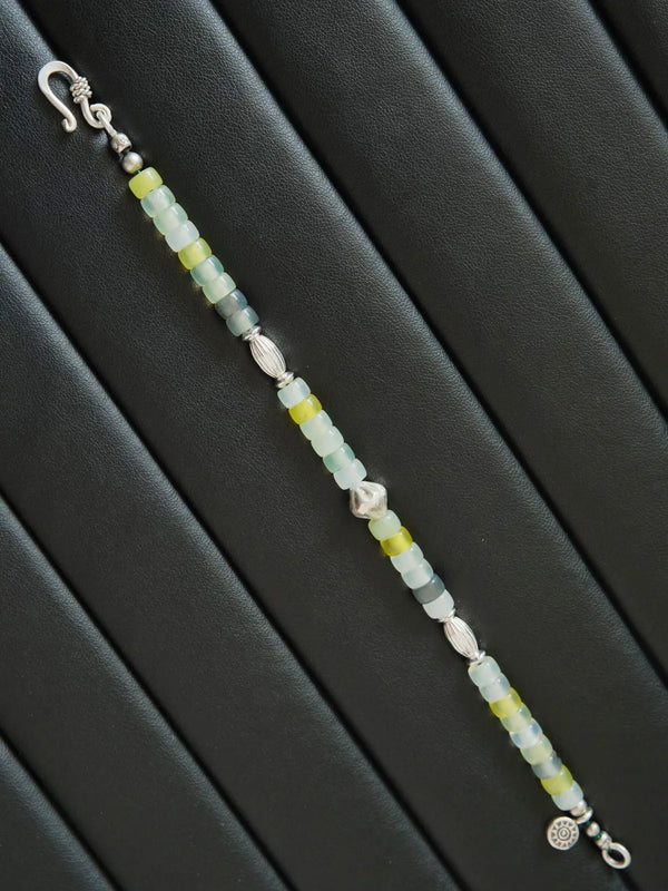 Artistic display of Silent Stone men’s bracelet with serpentine jade, silver details, and refined mineral-inspired design