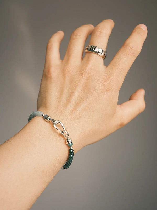 Close-up wrist shot of Ocean Bone men’s blue jade bracelet, a clean minimalist accessory with gradient jade and steel clasp
