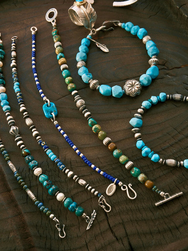 Turquoise and silver men’s bracelet collection displayed together for minimalist stacking inspiration