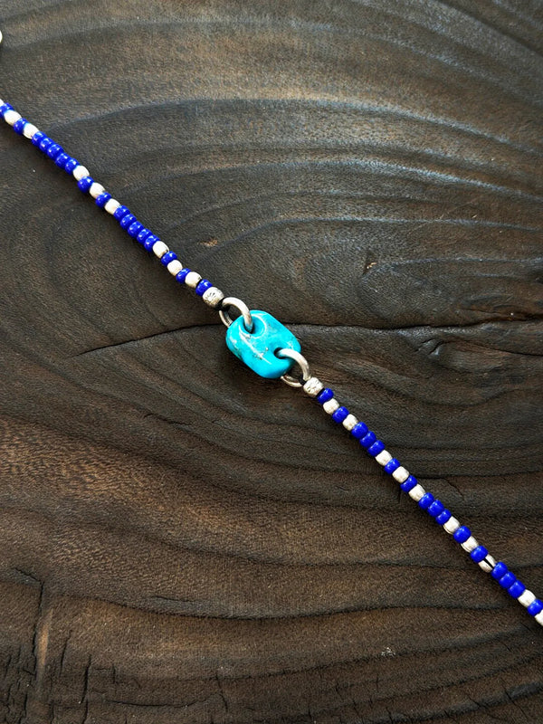 Close-up detail of turquoise stone, sterling silver accents, and blue Japanese colored-glaze beads