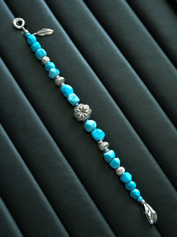 Stoic masculine bracelet aesthetic with turquoise stone and silver feather symbolism in monochrome mood