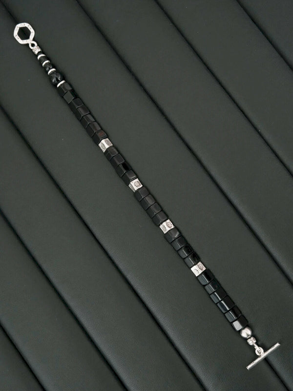 Minimal men’s black onyx bracelet styled with office wear and silver accessories, modern executive aesthetic