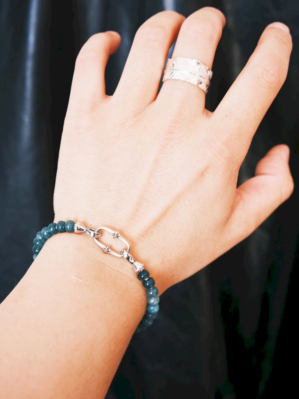 Blue jade bracelet styled for travel lifestyle and effortless masculine layering aesthetic