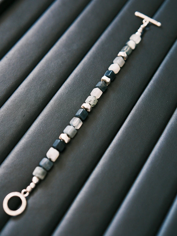 Black and white mood shot of a men’s geometric jade bracelet, designed for calm control, discipline, and masculine presence.