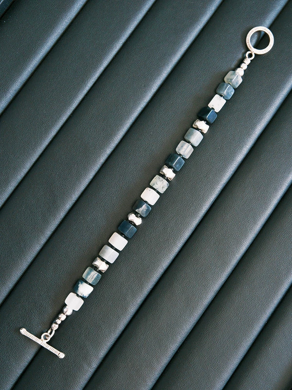 Black and white mood shot of a men’s geometric jade bracelet, designed for calm control, discipline, and masculine presence.