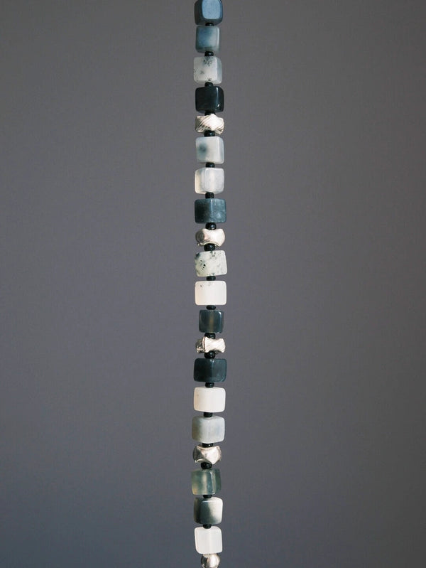 Close-up of natural jade, silver details, and Miyuki colored-glaze beads on a structured men’s beaded bracelet.