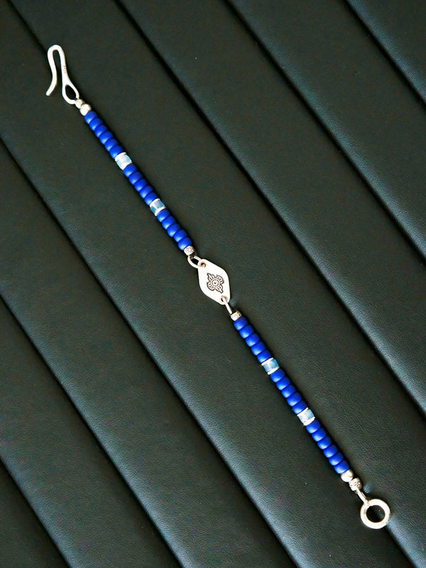 Close-up detail of Japanese Miyuki colored-glaze beads, aquamarine spacers and silver hardware on a blue men’s bracelet