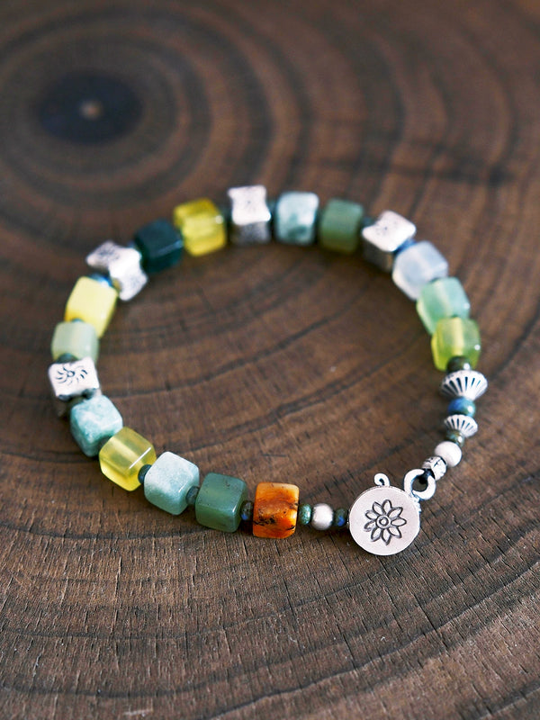 Close-up of colorful Xiuyan jade, 925 sterling silver and 990 fine silver details on men’s beaded bracelet