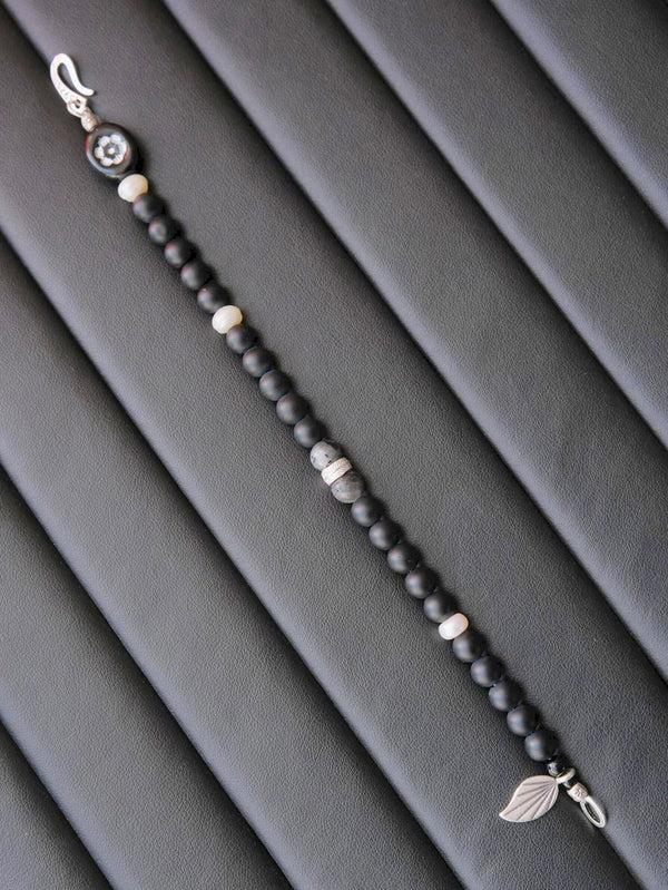 Black and white mood image for Identity Series Black Bloom bracelet, dark masculine jewelry aesthetic with quiet confidence.