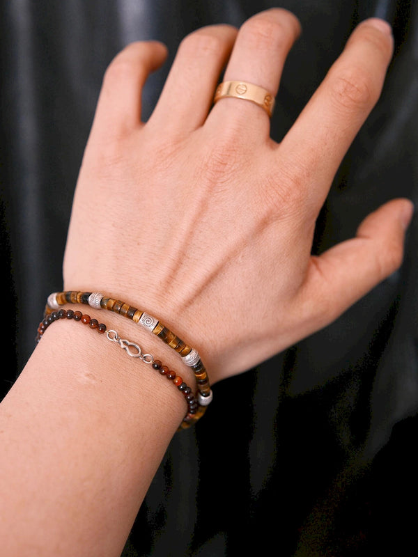 Tiger eye bracelet for men styled in a travel lifestyle scene, lightweight daily jewelry with grounded energy and refined masculine detail.