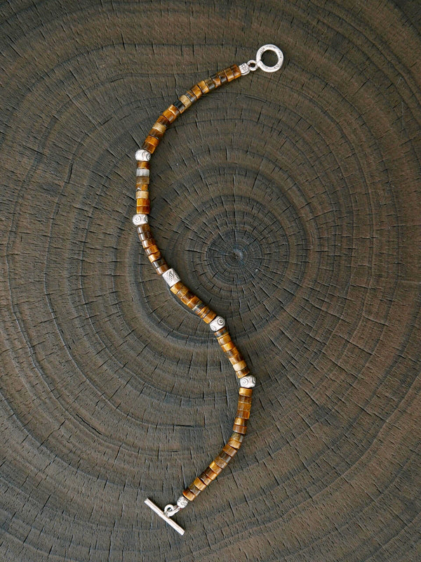 Black and white lifestyle image of men’s beaded bracelet styling, Urban Stoic jewelry aesthetic with calm masculine presence.