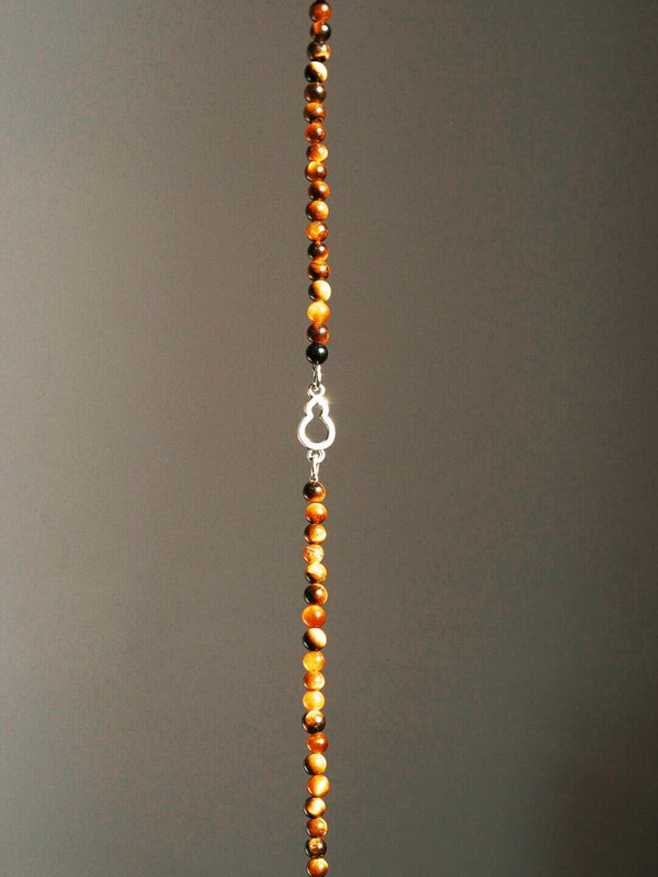 Men’s tiger eye bracelet styled in a minimal work setting, paired with a clean desk aesthetic for focus, discipline, and refined daily presence.