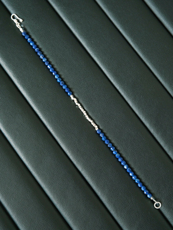 Moody black and blue jewelry image featuring a slim lapis lazuli men’s bracelet, quiet confidence aesthetic and refined masculine styling.