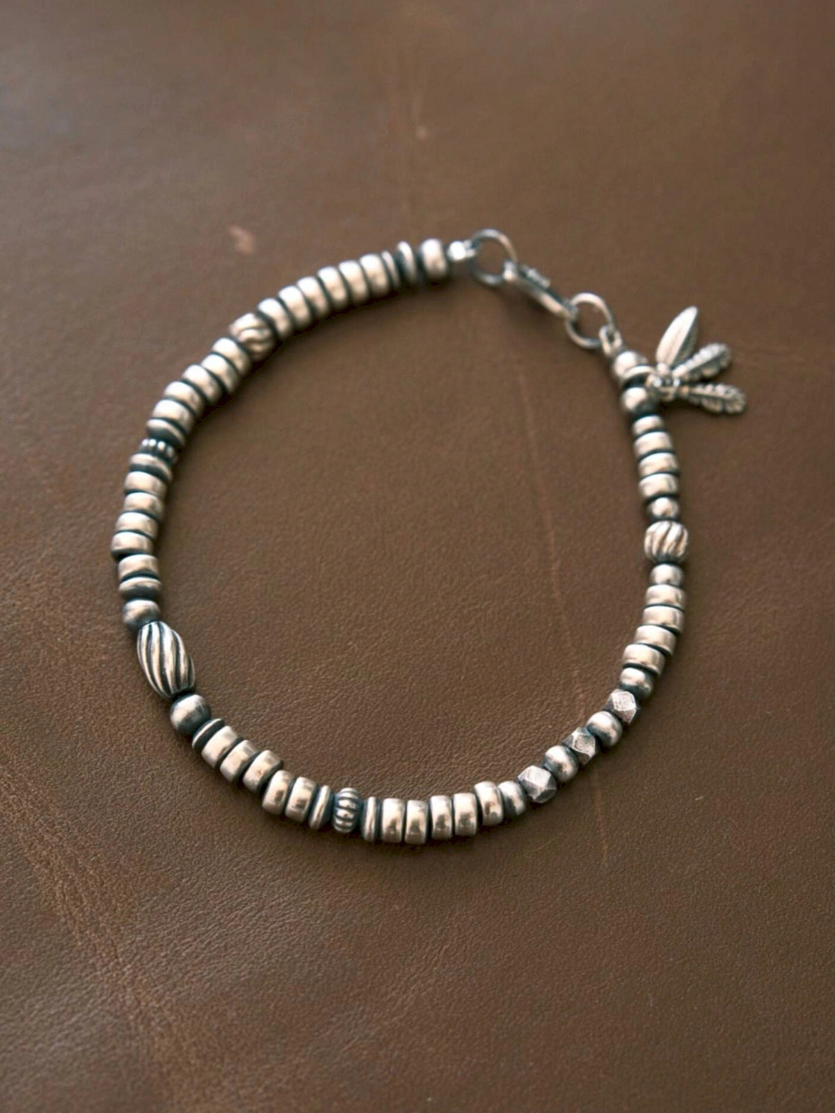 Men's 925 silver feather bracelet on brown leather, minimalist vintage silver jewelry product view