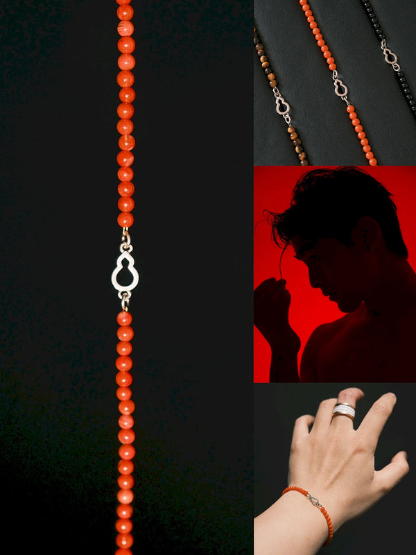 Flat lay of Identity Series Red FuLu men’s bracelet with full-color Nanhong agate beads and sterling silver gourd charm on dark leather background.
