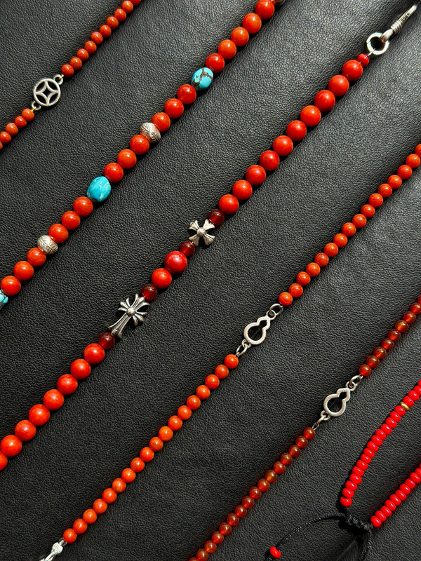 Meaningful red bracelet gift for him, Identity Series Red Creed, coral, cinnabar, red agate and sterling silver details in refined gift setting.