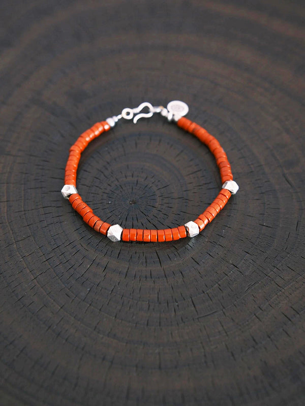 Men’s red stone bracelet with hammered silver worn during travel, lightweight daily bracelet for intentional lifestyle