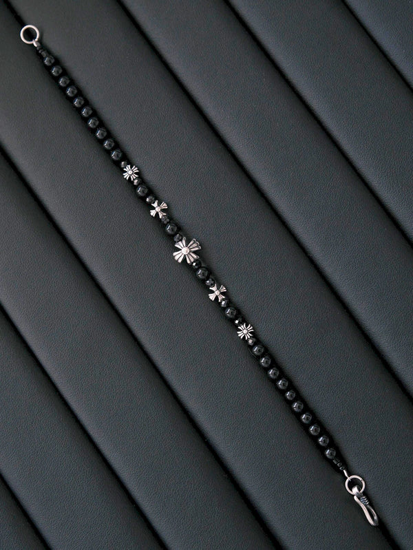 Black and white mood image with men’s dark minimalist bracelet, masculine jewelry aesthetic, quiet control and urban presence