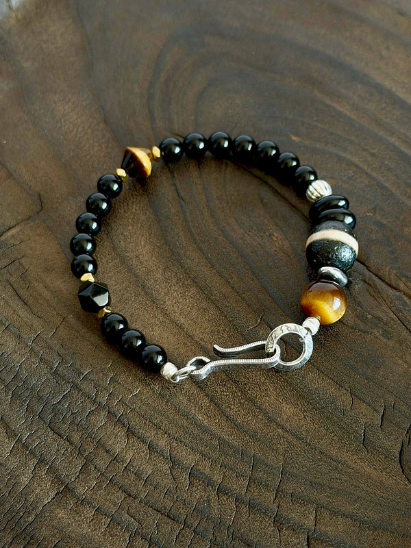 Men’s obsidian bracelet, Urban Stoic Series Black Dominion, minimal jewelry aesthetic with tiger eye and silver details.