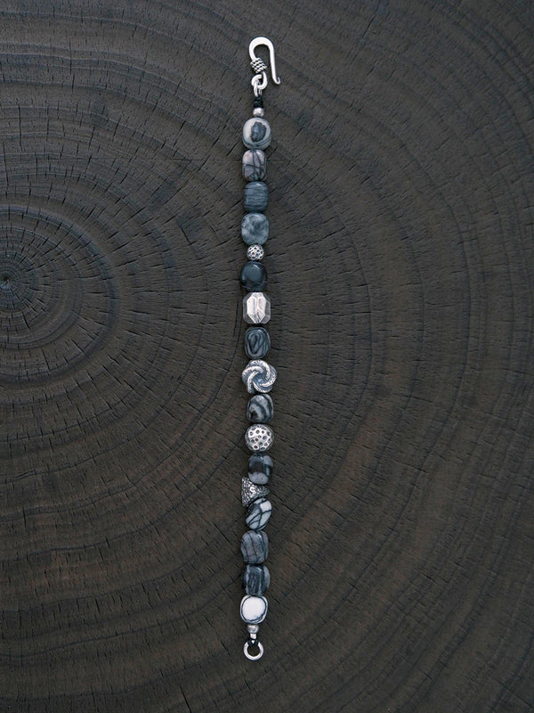 Black and grey mood image of Urban Stoic Series Grey Orbit bracelet, masculine jewelry aesthetic with quiet control.