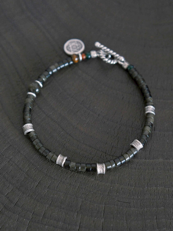 Men’s golden obsidian bracelet styled in a minimal work setting, designed for business casual outfits and refined daily presence.