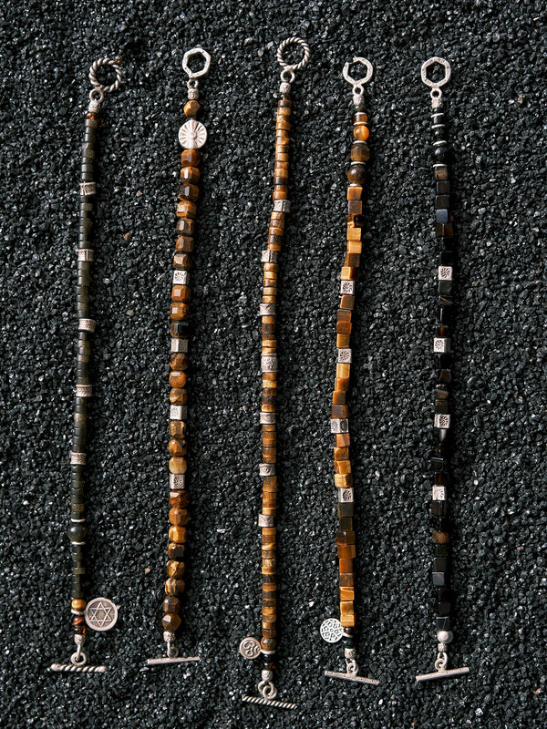 Black Astra men’s golden obsidian bracelet presented as a meaningful gift for him, with refined mineral beads and hammered silver details.