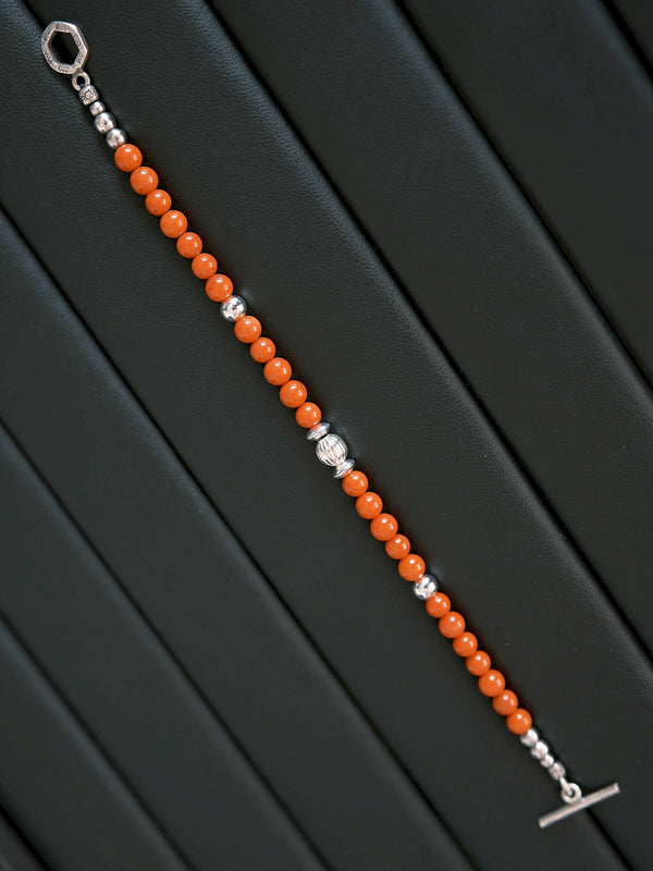 Men’s red agate bracelet styled with a minimal work outfit, silver accents, and quiet confidence aesthetic