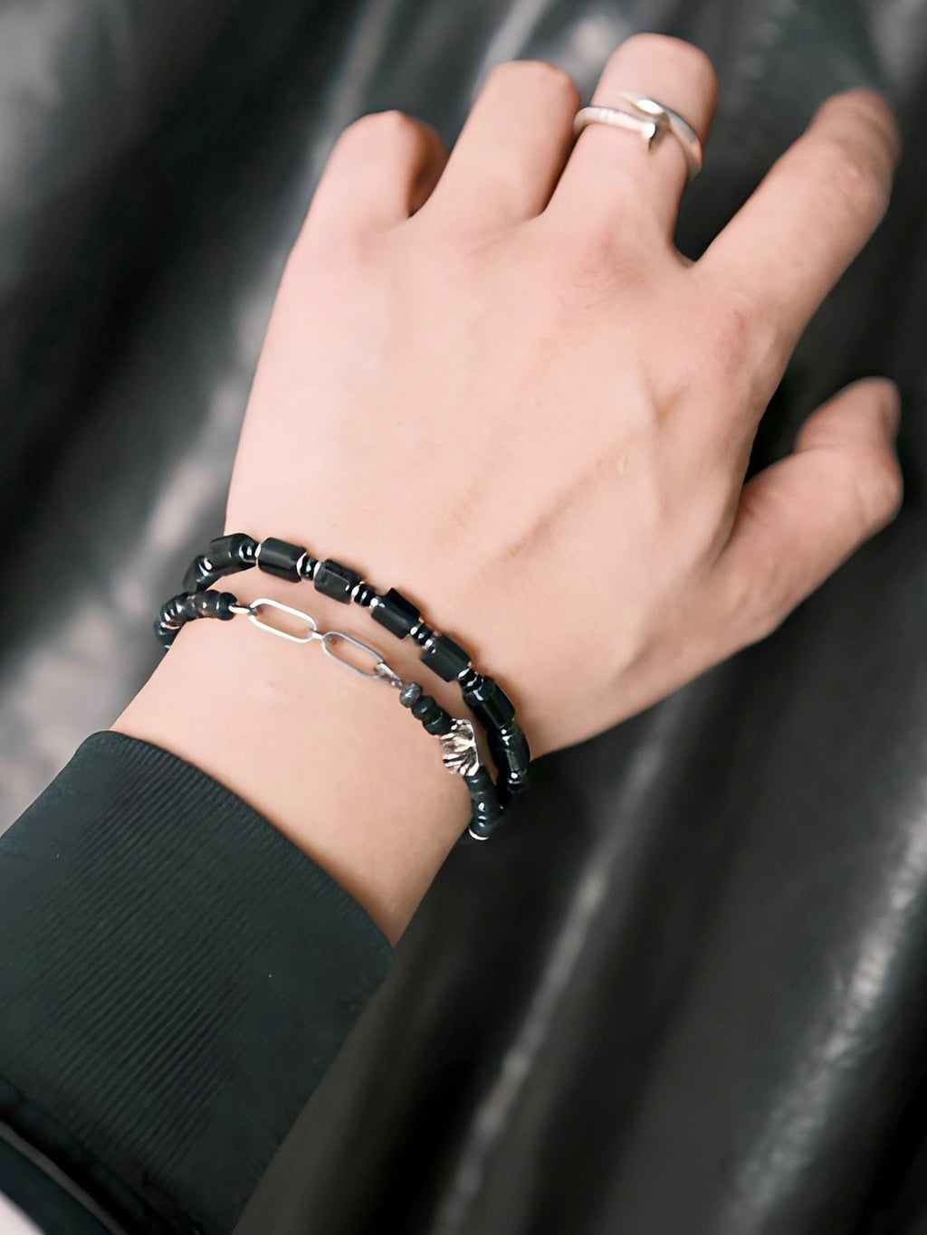 Men wearing Urban Stoic Series Black Verdict bracelet on wrist, black onyx and hematite beads, minimal everyday jewelry style.