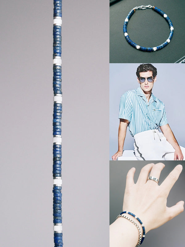 Flat lay of men’s blue beaded bracelet on dark leather surface, crafted with lapis lazuli, mother-of-pearl accents, and refined platinum-tone details.