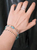 Stacked men’s bracelet styling with turquoise, pearl and silver bracelet, minimal summer jewelry aesthetic