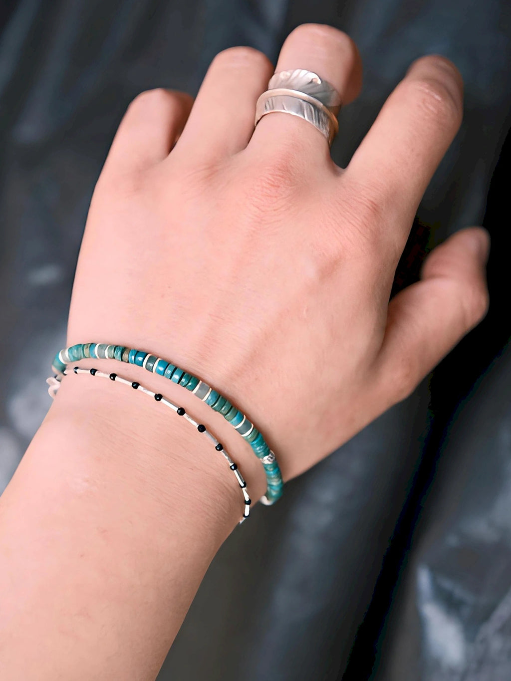 Stacked men’s bracelet styling with turquoise, pearl and silver bracelet, minimal summer jewelry aesthetic