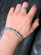 Stacked men’s bracelet styling with turquoise, pearl and silver bracelet, minimal summer jewelry aesthetic