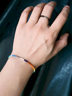 Close-up wrist shot of Identity Series Neon Thread bracelet, ultra-thin colored-glaze beads and sterling silver detail