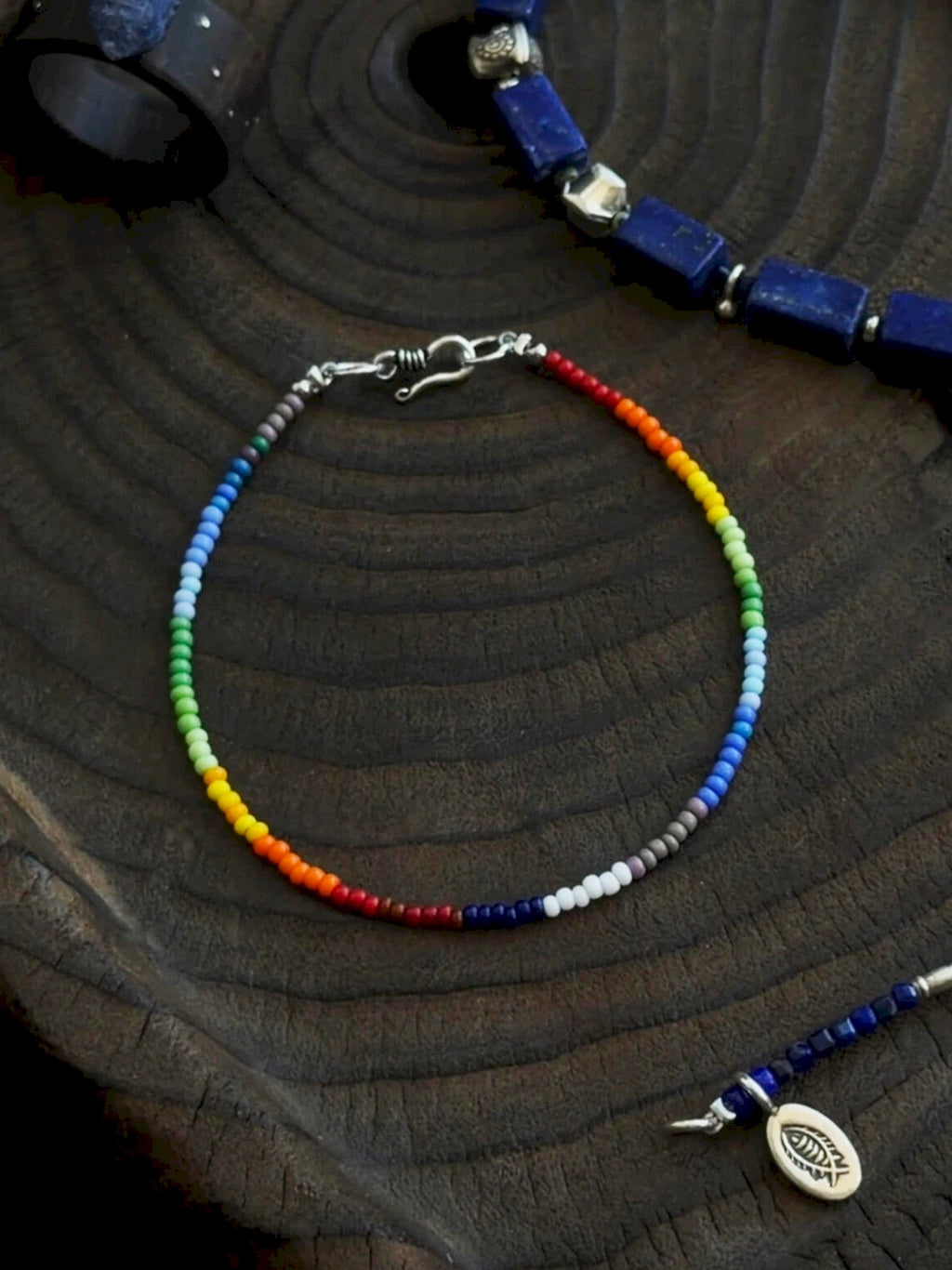 Close-up of imported colored-glaze beads and 925 silver clasp, fine rainbow bracelet detail, minimalist men’s accessory
