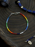 Close-up of imported colored-glaze beads and 925 silver clasp, fine rainbow bracelet detail, minimalist men’s accessory