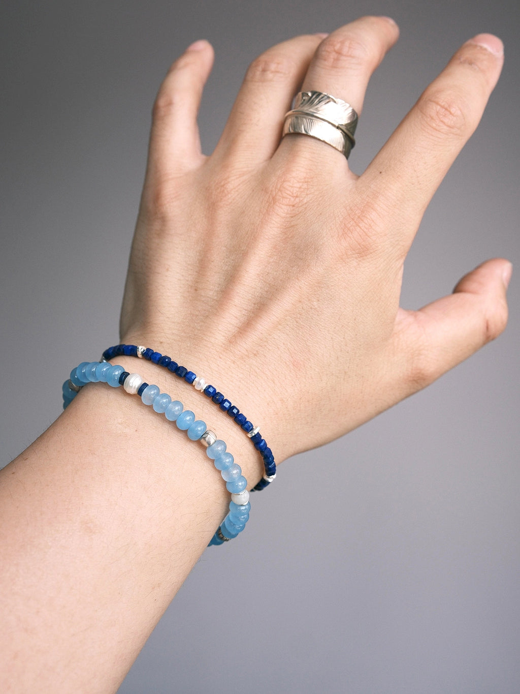 Stacked men’s bracelets with Blue Shoal blue chalcedony bracelet and slim lapis bracelet, refined daily wrist style