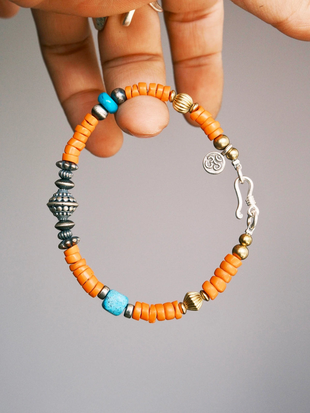 Men’s turquoise bracelet, Identity Series Sunset Nomad, minimal jewelry aesthetic with sterling silver and sunset orange colored-glaze.