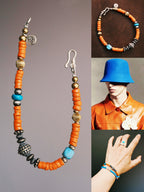 Sunset Nomad men’s beaded bracelet laid flat on dark textured wood, turquoise, sterling silver, refined brass, and antique Japanese colored-glaze in a vintage western style.