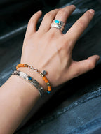 Men’s stacking bracelet look with turquoise, sterling silver, blue beads, and sunset orange colored-glaze, relaxed masculine wrist style.