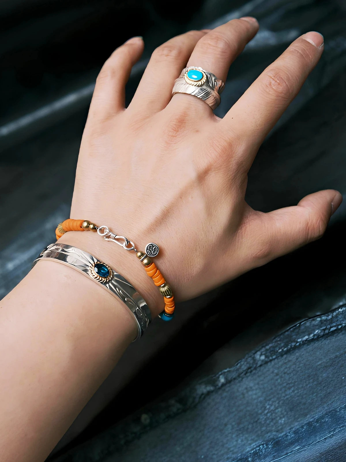 Men’s stacking bracelet look with turquoise, sterling silver, blue beads, and sunset orange colored-glaze, relaxed masculine wrist style.
