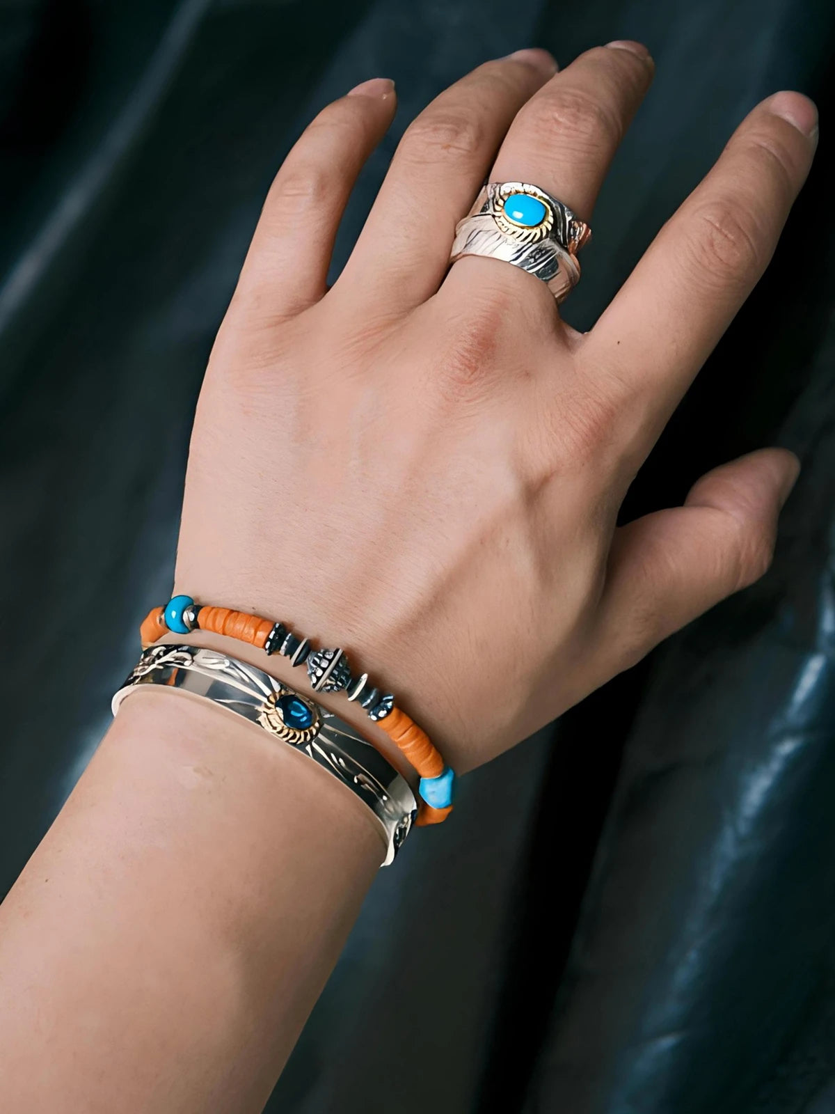 Close-up wrist shot of men’s turquoise bracelet with sunset orange beads, sterling silver clasp, and refined brass accents for grounded confidence.