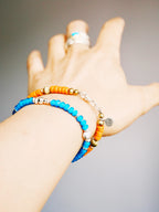 Weekend casual men’s bracelet styling with turquoise, sunset orange colored-glaze, denim-friendly vintage western aesthetic.