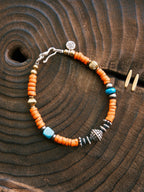 Men’s turquoise and sunset orange bracelet styled for travel, vintage western bracelet with sterling silver and colored-glaze details.