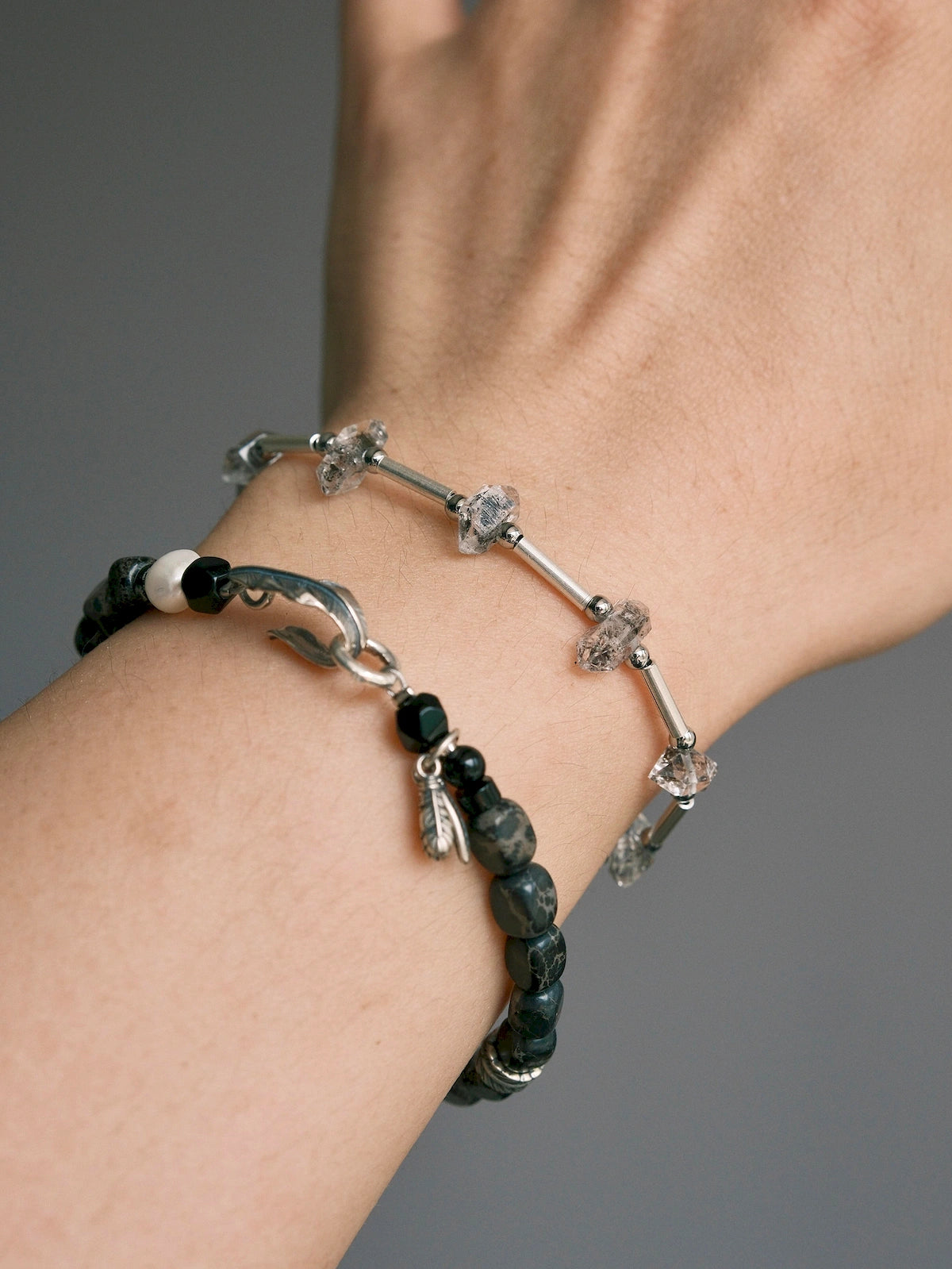 Close wrist shot of men’s Herkimer quartz bracelet, raw crystal edges and polished sterling silver tube details